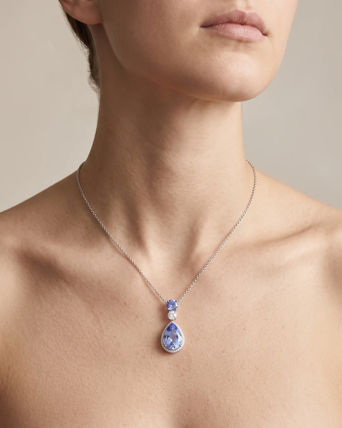 ORTIGAS Blue Pear Drop necklace, worn on the neck
