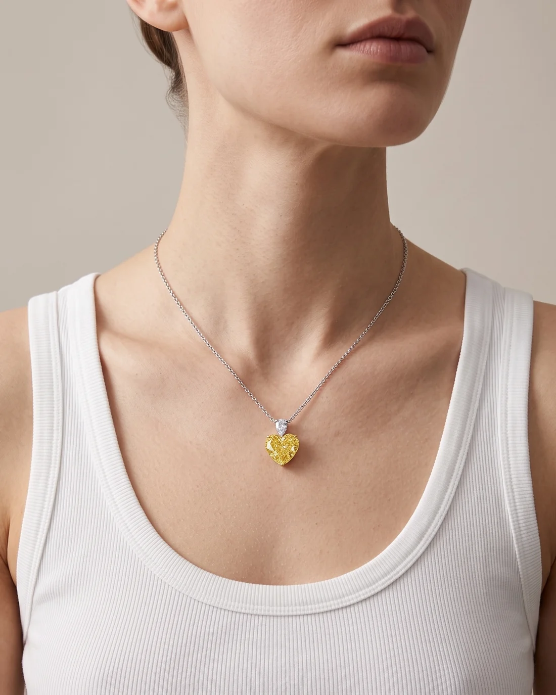 ORTIGAS Yellow Heart Drop necklace, worn on the neck